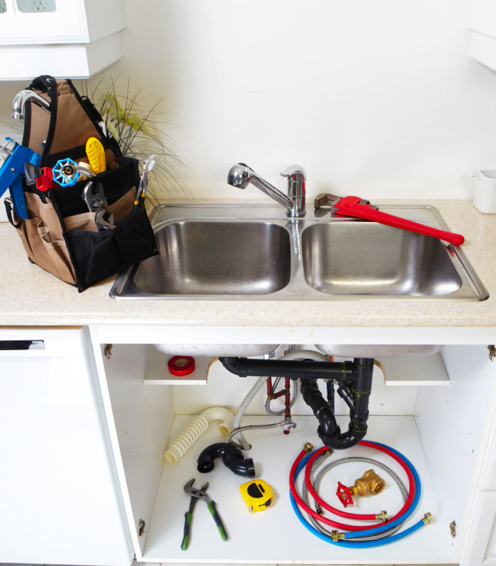 plumbing tools and essentials on kitchen sink